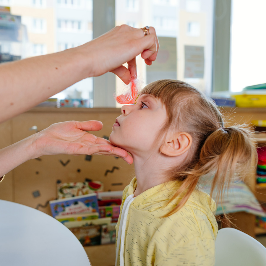Niña realizando un ejercicio de estimulación con una profesional